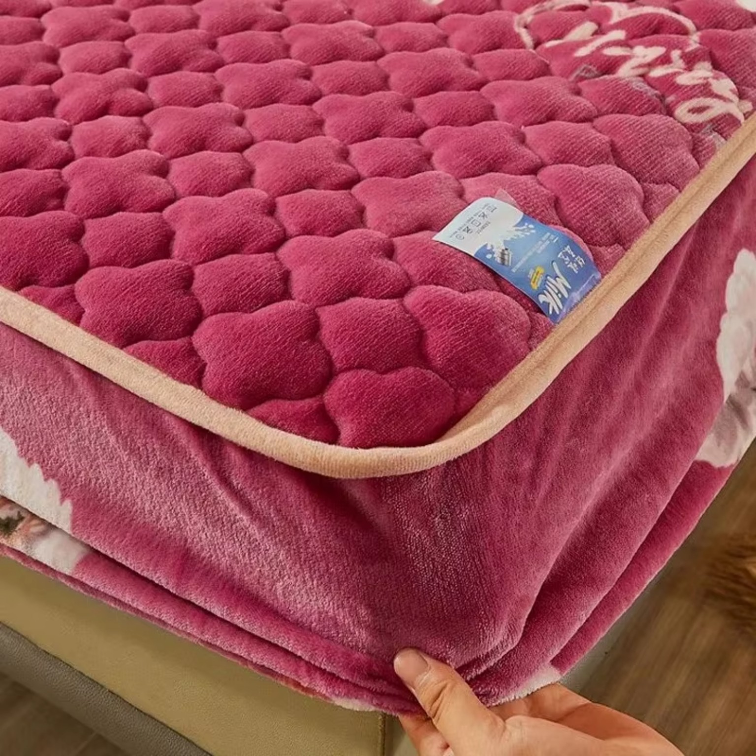 Close-up of quilted plush fabric and edge binding